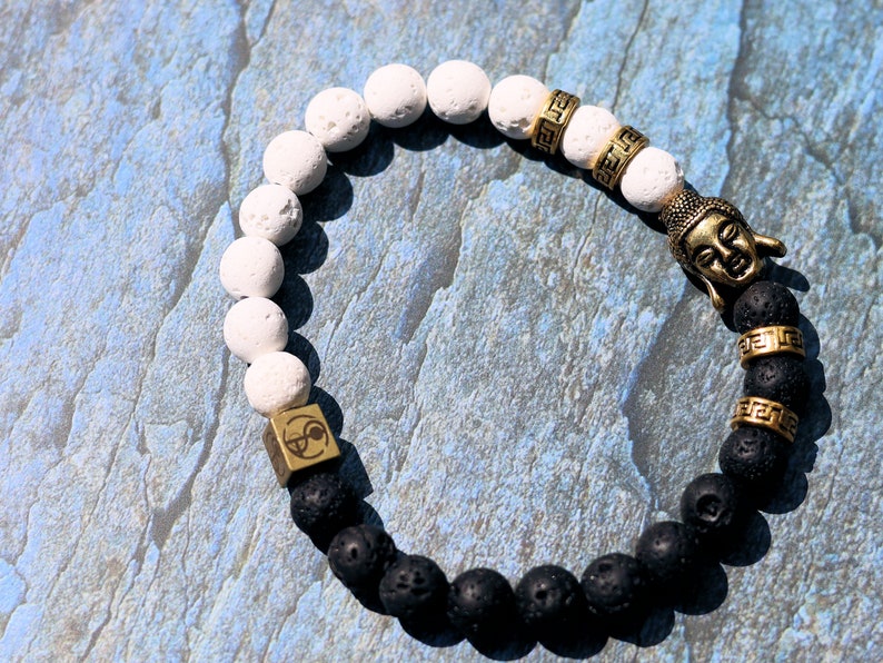 Astral black and white lava bracelet with Antique Style Buddha head and Wajakaa © Logo bead. provides strength and clear thinking