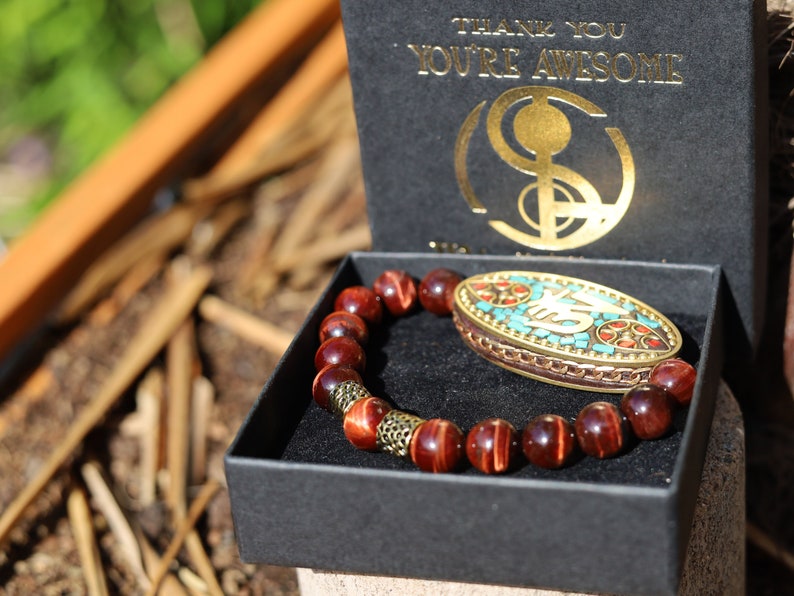 Swank Red Tiger Eye bracelet combined with a Handmade big truly inspiring Indonesia Bead. "The jewel is in the lotus".