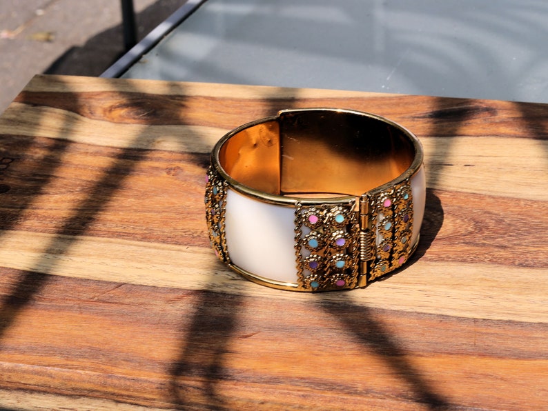 Kriaa Gold Plated Multicolor Stone Kada. Indian jewelry is known for its intricate designs and rich cultural significance.
