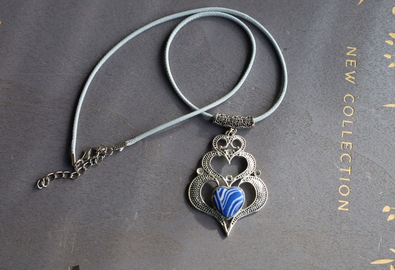 925 Silver Plated Blue white Calsilica Calsilica,, is a man-made material known for its distinctive, highly individual appearance and vibrant layers of bold color.