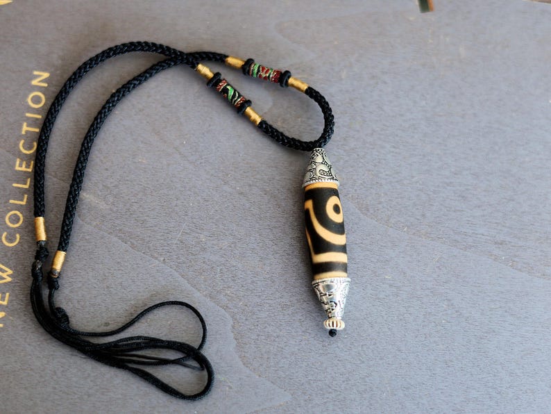 Rare to find, Old The Two-Eye dZi bead is a powerful symbol of love, marital harmony, and balanced relationships.