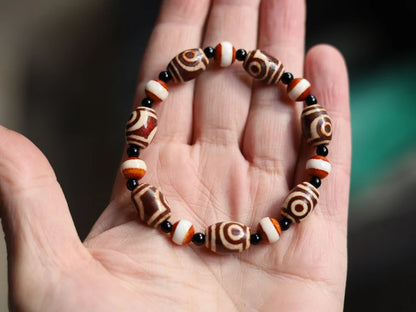 Tibetan Collections Two Eyes Dzi Bead.  These Dzi beads are known as Love Stones. Designed and handmade and stringed by strong elastic cords