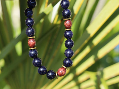 Goldstone combined with wooden beads with engraved stylized spiral decoration and Heishi beads: real (light magnetic) Hematite