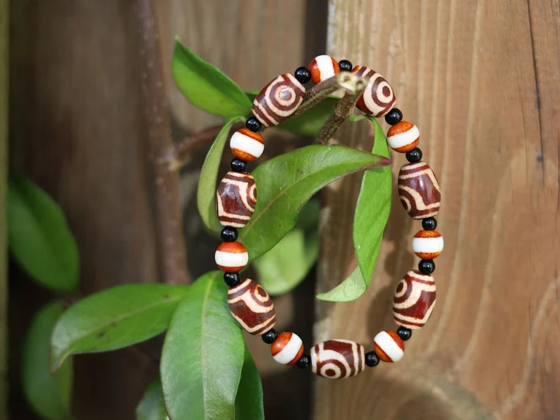 Tibetan Collections Two Eyes Dzi Bead.  These Dzi beads are known as Love Stones. Designed and handmade and stringed by strong elastic cords