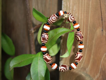 Tibetan Collections Two Eyes Dzi Bead.  These Dzi beads are known as Love Stones. Designed and handmade and stringed by strong elastic cords
