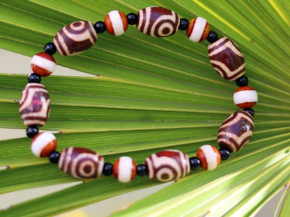 Tibetan Collections Two Eyes Dzi Bead.  These Dzi beads are known as Love Stones. Designed and handmade and stringed by strong elastic cords