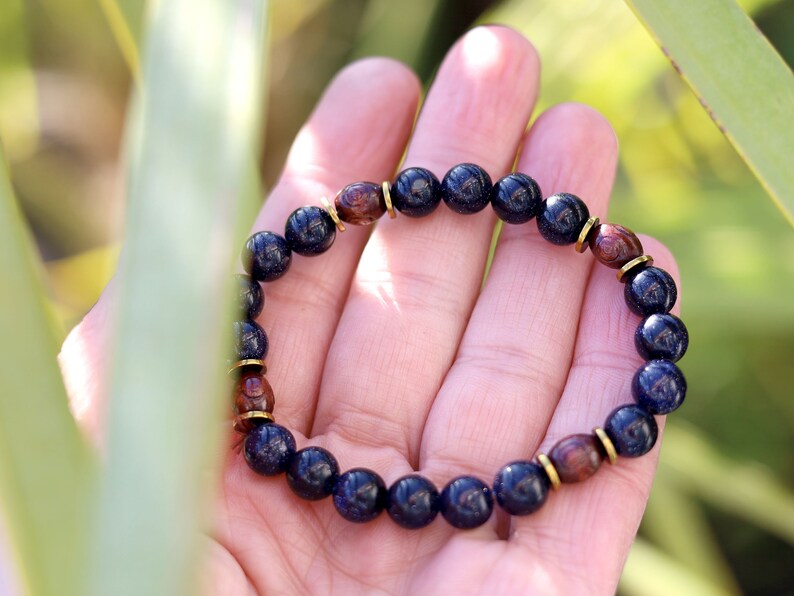 Goldstone combined with wooden beads with engraved stylized spiral decoration and Heishi beads: real (light magnetic) Hematite