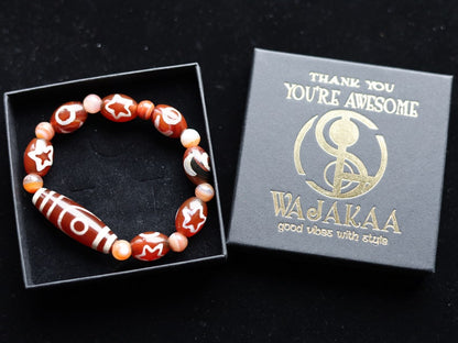 Two-eye dZi bead with Universe Dzi Bead | Sun/Moon. The sun, moon, and star painted on this Dzi bead represent this universal life energy.