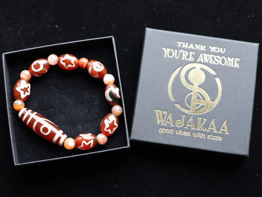 Two-eye dZi bead with Universe Dzi Bead | Sun/Moon. The sun, moon, and star painted on this Dzi bead represent this universal life energy.