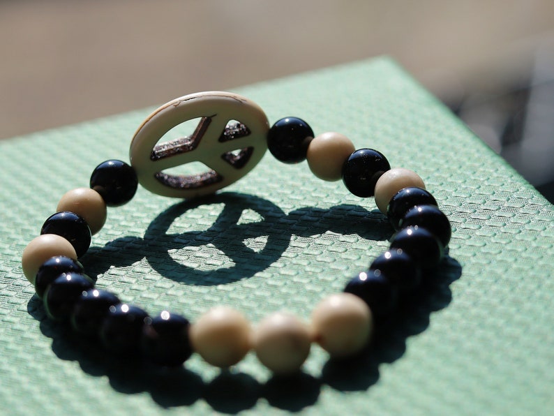 Viśēśa Jewel Collection - WORLD PEACE bracelet with White Jasper, black Onyx.  It also opens, heals, and activates the Root Chakra.