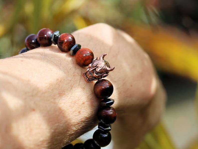 Enticing RED Tiger's Eye crystal combined with Devil Style Alloy Bead. Red Tiger Eye, or Dragon’s Eye, is Tiger Eye with red shades and hues