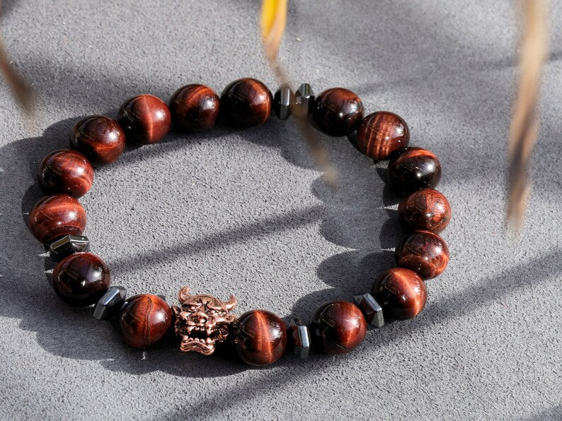 Enticing RED Tiger's Eye crystal combined with Devil Style Alloy Bead. Red Tiger Eye, or Dragon’s Eye, is Tiger Eye with red shades and hues