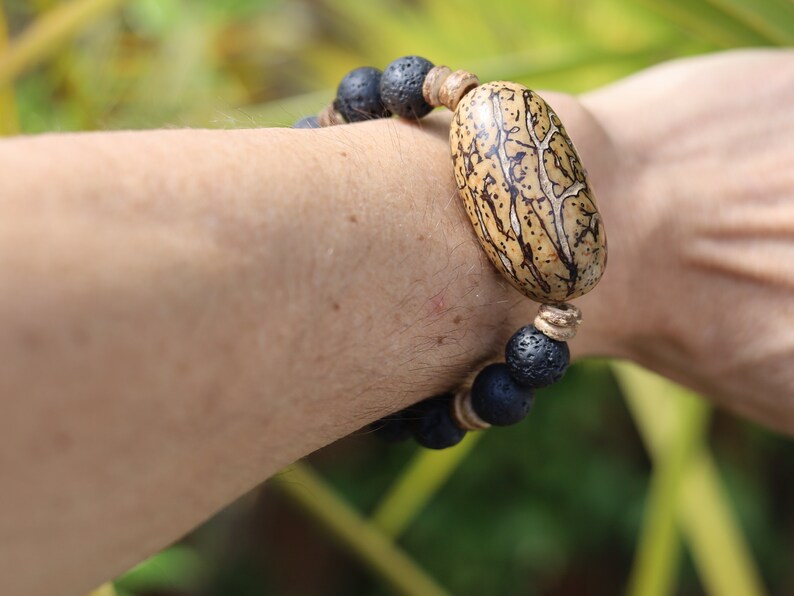 Special big  Lava stones bracelet with beautiful and very large bead: Tropical Seed/Kernel. Buddha Tree Seeds Bead.