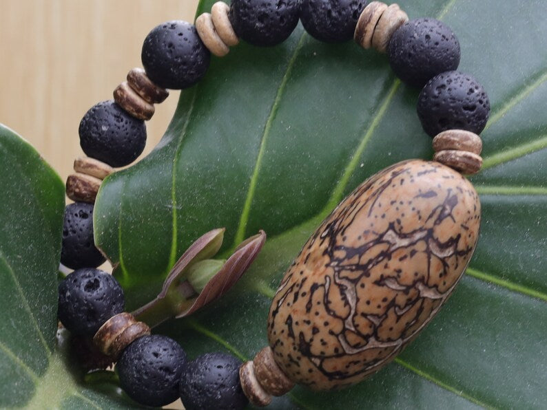 Special big  Lava stones bracelet with beautiful and very large bead: Tropical Seed/Kernel. Buddha Tree Seeds Bead.