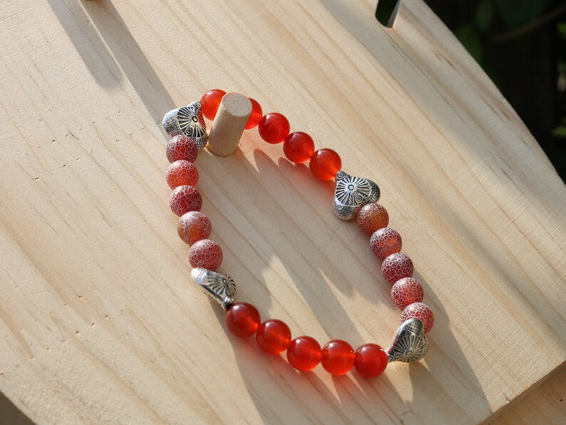 Subliminal Carnelian combined with Matte Frosted Agate Beads and beautiful Tibetan Style Carved Heart. Efficient, positive communication.