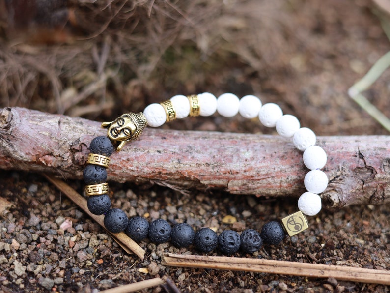 Astral black and white lava bracelet with Antique Style Buddha head and Wajakaa © Logo bead. provides strength and clear thinking