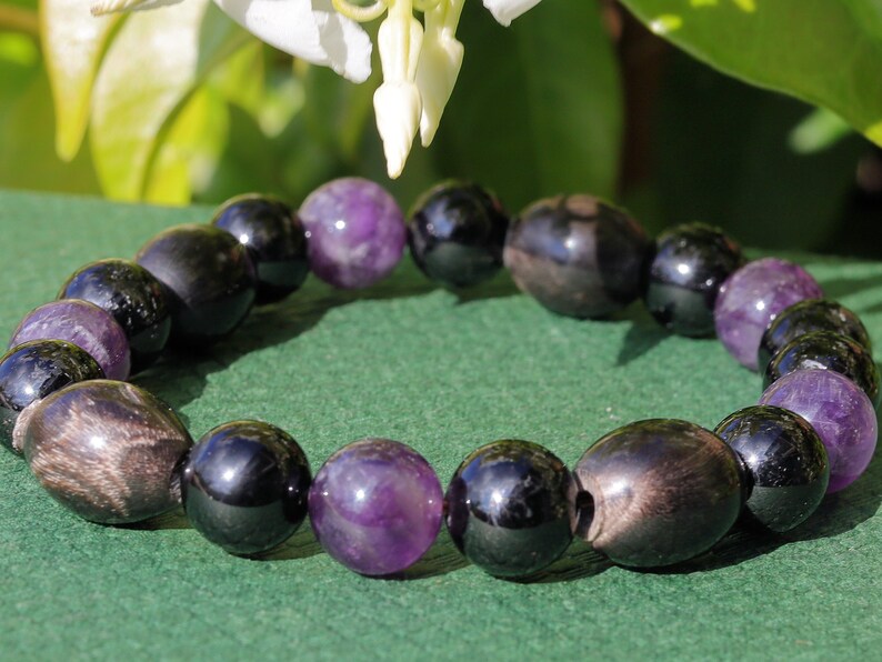 Far-out Tourmaline and Amethyst crystal bracelet with A very nice set of 4 handmade Horn Beads.  presence of compassion and wisdom