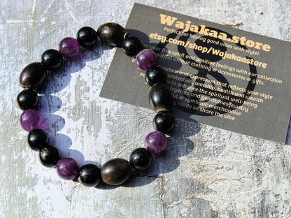 Far-out Tourmaline and Amethyst crystal bracelet with A very nice set of 4 handmade Horn Beads.  presence of compassion and wisdom