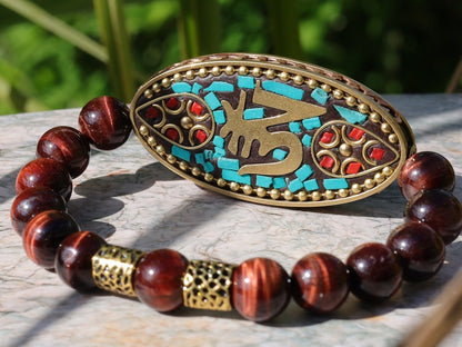 Swank Red Tiger Eye bracelet combined with a Handmade big truly inspiring Indonesia Bead. "The jewel is in the lotus".