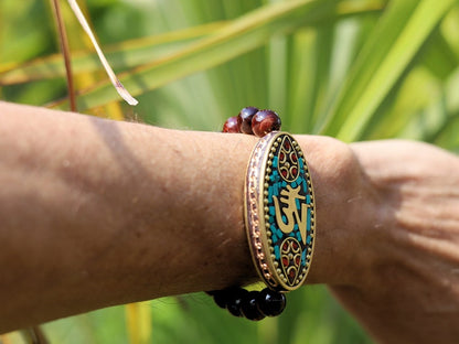 Swank Red Tiger Eye bracelet combined with a Handmade big truly inspiring Indonesia Bead. "The jewel is in the lotus".