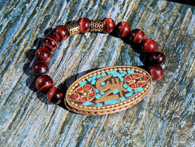 Swank Red Tiger Eye bracelet combined with a Handmade big truly inspiring Indonesia Bead. "The jewel is in the lotus".