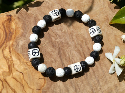 Peaceful black and white Lava stones bracelet combined with Ceramic Cube Peace Sign. Designed for the British nuclear disarmament movement