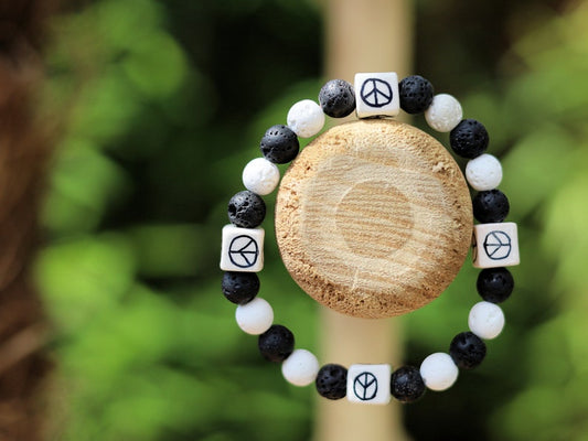 Peaceful black and white Lava stones bracelet combined with Ceramic Cube Peace Sign. Designed for the British nuclear disarmament movement