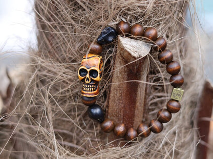 Odd wooden bracelet with Polyresin Mens Skull Bead. Unique and shows the vital Buddhist symbol of emptiness the quality of the universe.