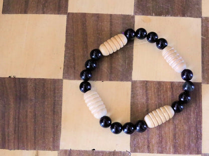 Easy going Natural Obsidian Grade AA, with Turned wooden beads. Symbolically, wood has a strong connection with the Earth and nature.
