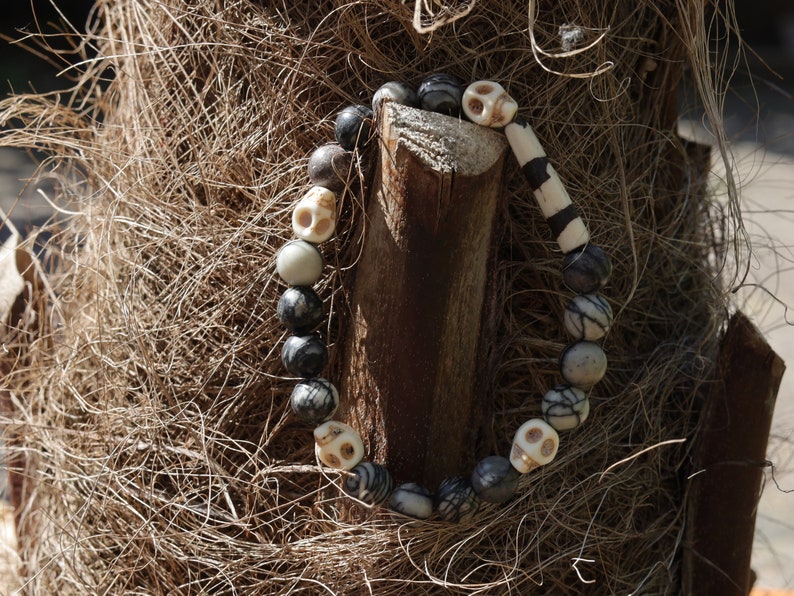 Special black silk stone bracelet with handmade Batik bone bead and detailed hand-carved prayer skull beads. Fantastic beads!