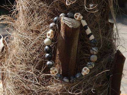 Special black silk stone bracelet with handmade Batik bone bead and detailed hand-carved prayer skull beads. Fantastic beads!