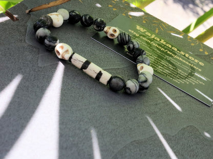 Special black silk stone bracelet with handmade Batik bone bead and detailed hand-carved prayer skull beads. Fantastic beads!