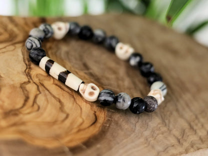 Special black silk stone bracelet with handmade Batik bone bead and detailed hand-carved prayer skull beads. Fantastic beads!