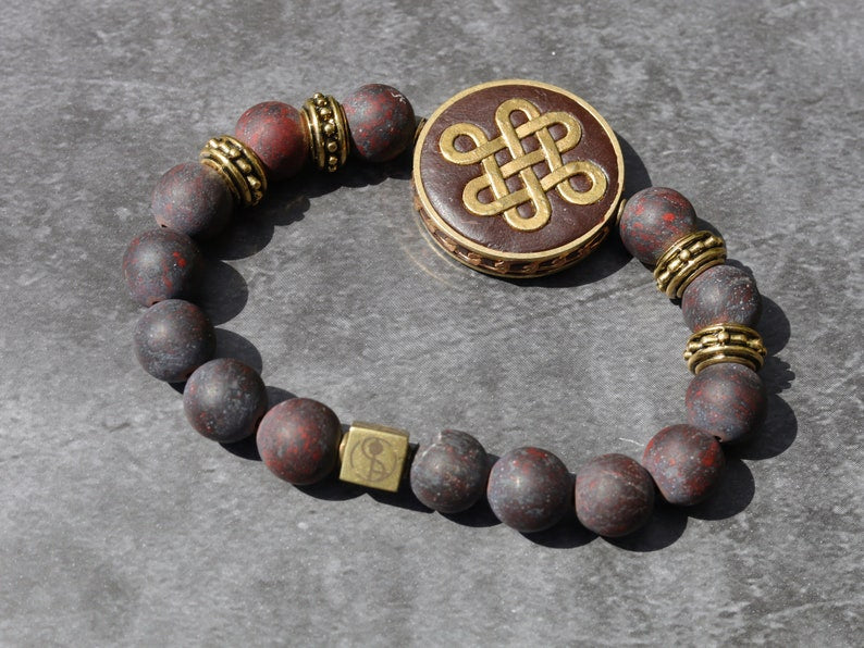 Adventurous Natural Saffron Jasper Beads , High Quality in Matte Round. Combined with Chinese Knot and a Wajakaa © Logo bead.