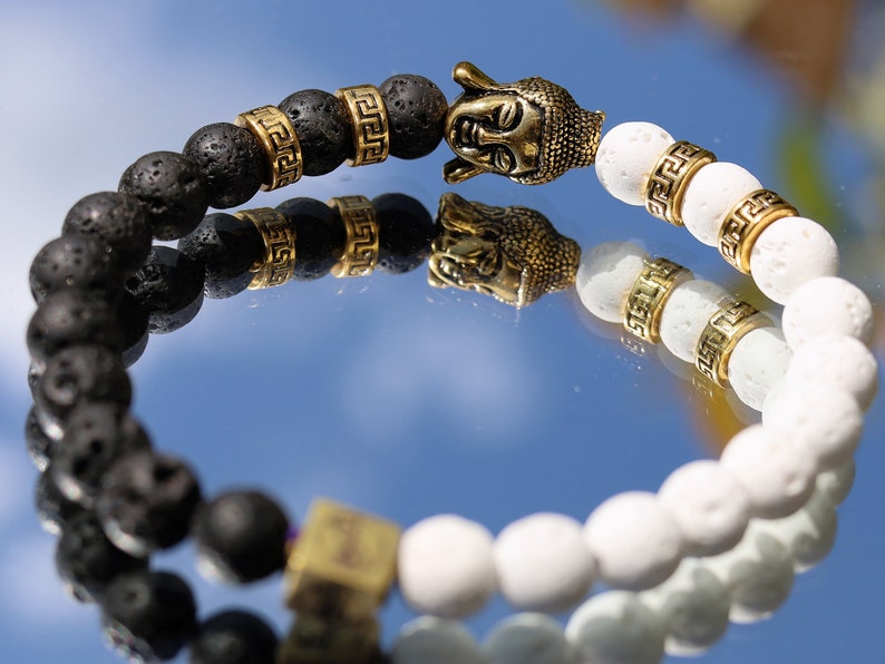 Astral black and white lava bracelet with Antique Style Buddha head and Wajakaa © Logo bead. provides strength and clear thinking