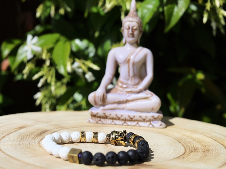 Astral black and white lava bracelet with Antique Style Buddha head and Wajakaa © Logo bead. provides strength and clear thinking