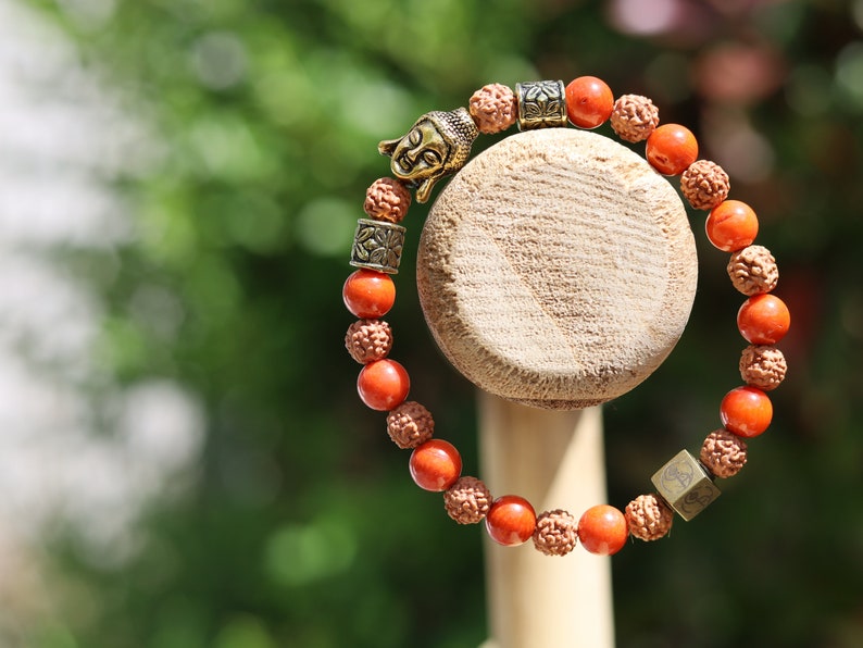 Godlike Red Coral / Rudraksha bracelet with Antique Style Buddha head and Wajakaa © Logo bead.  ‘one who is awake’