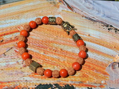 Godlike Red Coral / Rudraksha bracelet with Antique Style Buddha head and Wajakaa © Logo bead.  ‘one who is awake’
