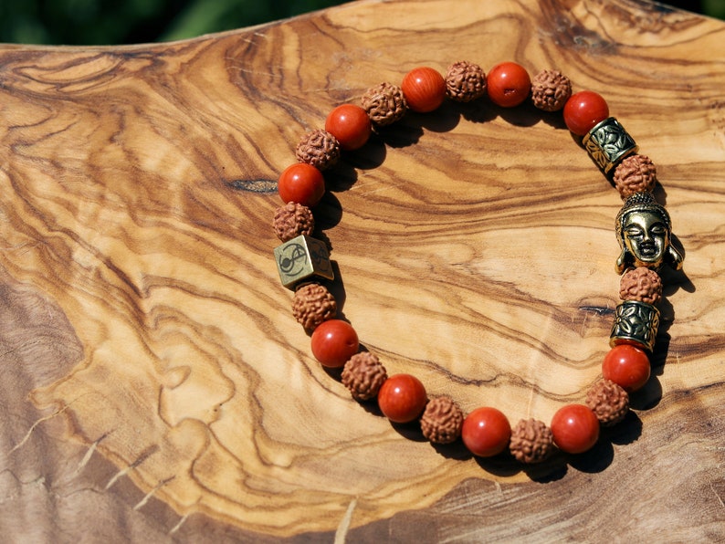 Godlike Red Coral / Rudraksha bracelet with Antique Style Buddha head and Wajakaa © Logo bead.  ‘one who is awake’