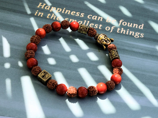 Godlike Red Coral / Rudraksha bracelet with Antique Style Buddha head and Wajakaa © Logo bead.  ‘one who is awake’