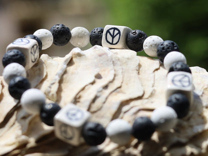 Peaceful black and white Lava stones bracelet combined with Ceramic Cube Peace Sign. Designed for the British nuclear disarmament movement