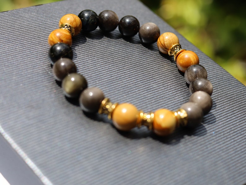 Engaging natural wood lace with Rainbow Obsidian combined Diabolo / Rondel. calming fears and insecurities and strengthening one’s courage.