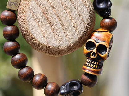 Odd wooden bracelet with Polyresin Mens Skull Bead. Unique and shows the vital Buddhist symbol of emptiness the quality of the universe.