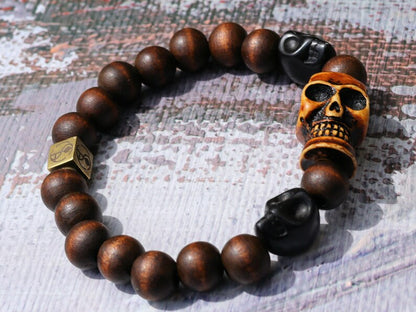 Odd wooden bracelet with Polyresin Mens Skull Bead. Unique and shows the vital Buddhist symbol of emptiness the quality of the universe.