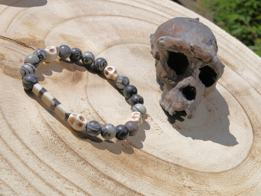 Special black silk stone bracelet with handmade Batik bone bead and detailed hand-carved prayer skull beads. Fantastic beads!