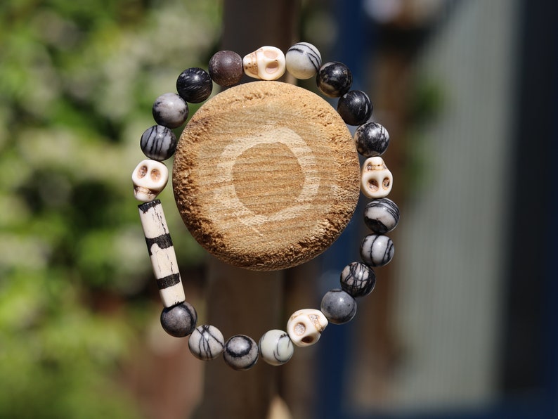 Special black silk stone bracelet with handmade Batik bone bead and detailed hand-carved prayer skull beads. Fantastic beads!