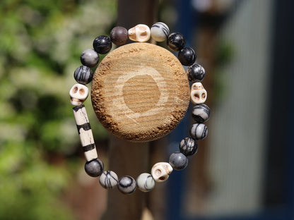 Special black silk stone bracelet with handmade Batik bone bead and detailed hand-carved prayer skull beads. Fantastic beads!