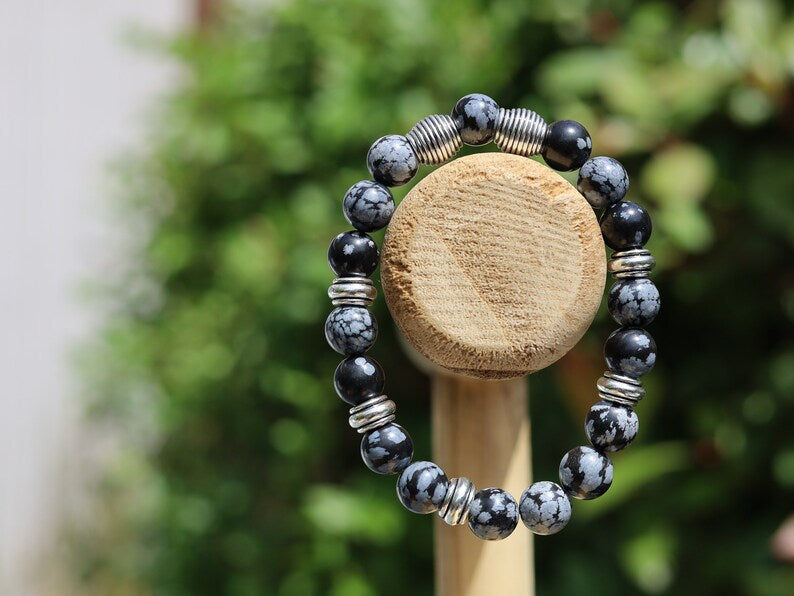Astonishing 11 mm Snowflake Obsidian bracelet with Antique Silver, Rondelle. It can bring about a balance to body, mind and spirit
