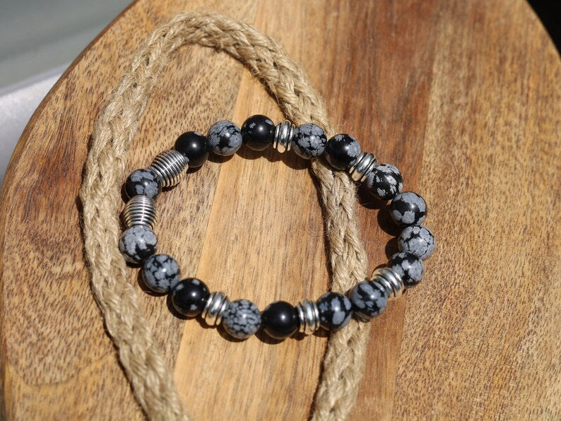 Astonishing 11 mm Snowflake Obsidian bracelet with Antique Silver, Rondelle. It can bring about a balance to body, mind and spirit