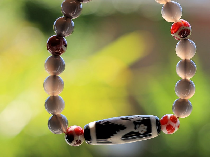 LIMITED EDITION Authentic Dragon Dzi Bead Agate . This precious bead is strung with new Natural Ice Obsidian Beads. Unique, handmade jewelry